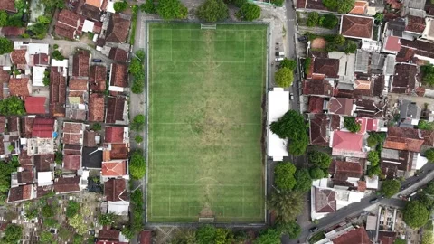 A downward-facing drone camera shows the teams playing on a mini soccer field Stock Footage 316759986