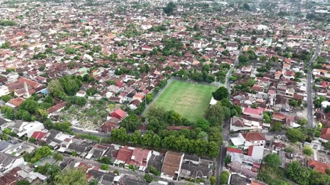 A downward-facing drone camera shows the teams playing on a mini soccer field Stock Footage 316760153
