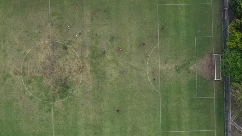 Downward-looking drone footage shows a mini soccer field playing ball. Located Stock Footage 316760018