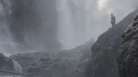 Downward Pan Of Adventure Seekers Exploring A Waterfall Stock Footage 61888934
