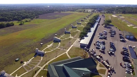 Downward Tiling Drone Establishing Shot of Event at Large Skeet Shooting Venue Stock Footage 75972501