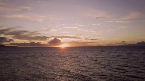 Downward Tilt Shot Of A Setting Sun Over Tropical Seas Video stock 83793885