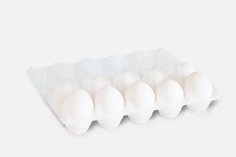 A dozen white eggs in shell on a white isolated background. Natural healthy f Stock Photos