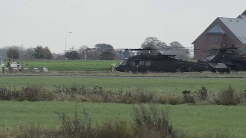 Dozens of Black Hawk and Apache helicopters in a field 2 Stock Footage 113297077