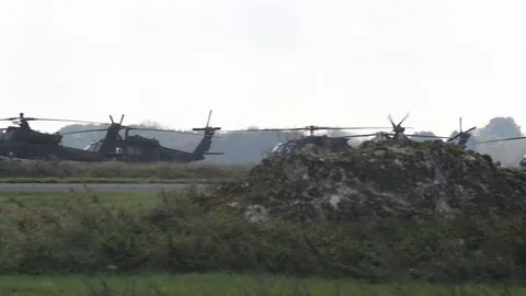 Dozens of Black Hawk and Apache helicopters in a field 4 Stock Footage 113297121
