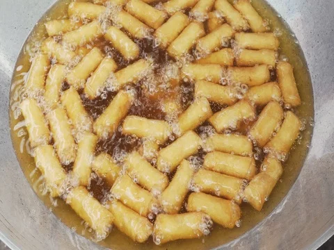 Dozens of crispy deep-fried spring roll in cooking oil Video stock 78574213