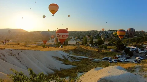 Dozens of hot air balloons launch at dawn over Goreme Stock Footage