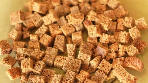 Dozens of small, rustic cubes of rye bread, like homemade croutons Stock Footage 329616233