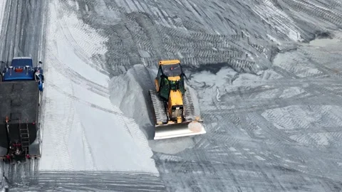 Dozer blade pushing stone across the graded base Stock Footage 346167087