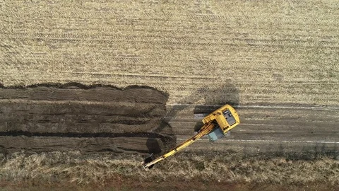 Dozer with bucket, preparing for macadam service road in a crop field. Stock Footage 101388917