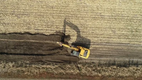 Dozer with bucket, preparing for macadam service road in a crop field. Stock Footage 101487998