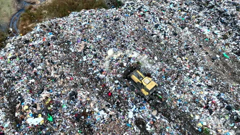Dozer on Garbage Dump. Landfill with solid household waste Stock Footage 220104765