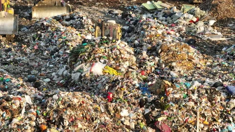 Dozer at landfill. Garbage dump with waste plastic Stock Footage 218392714