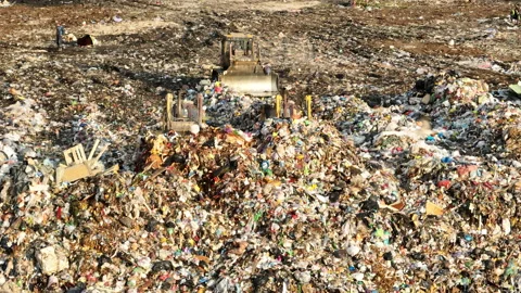 Dozer on landfill. Garbage dump with waste plastic Stock-Footage 218426905