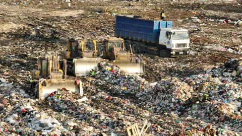 Dozer on landfill. Garbage dump with waste plastic Vídeo Stock 218426951