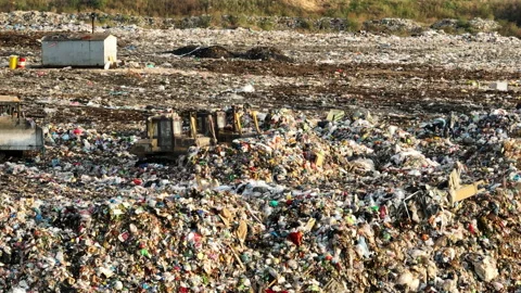 Dozer at landfill. Garbage dump with waste plastic Video stock 218427252