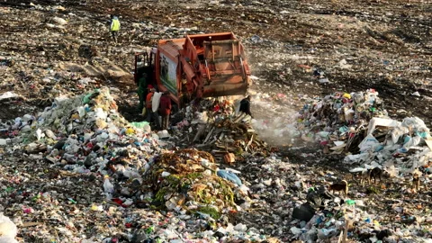 Dozer on landfill. Garbage dump with waste plastic Stock Footage 218428188