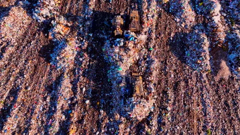 Dozer at landfill. Garbage dump with waste plastic, rubbish and polyethylene. Stock-Footage 219756567