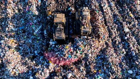 Dozer at landfill. Garbage dump with waste plastic, rubbish and polyethylene. Stock Footage 219757779