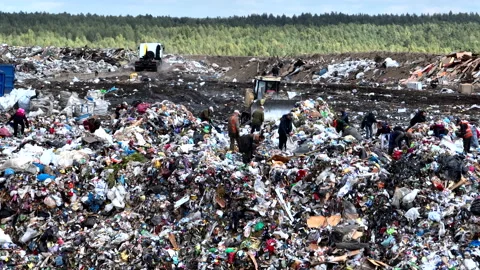 Dozer on landfill. Garbage dump with waste plastic, rubbish and polyethylene. Stock Footage 220105226
