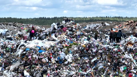 Dozer on landfill. Garbage dump with waste plastic, rubbish and polyethylene. Stock Footage 220105263