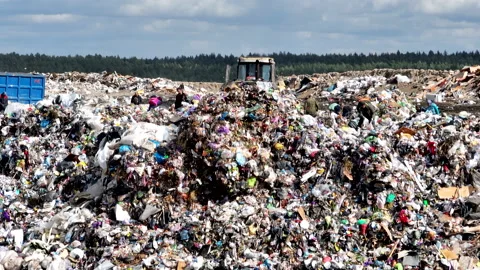 Dozer on landfill. Garbage dump with waste plastic, rubbish and polyethylene. Stock Footage 220105331