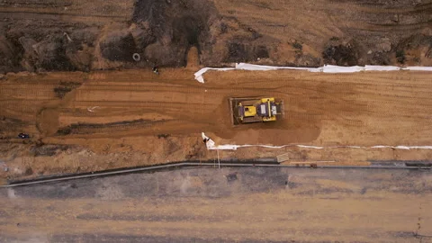 Dozer levels the ground during road construction, aerial view. Stock Footage 167562640
