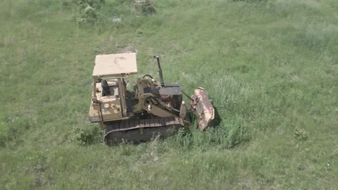 Dozer sitting in open grassfield Stock Footage 306827961