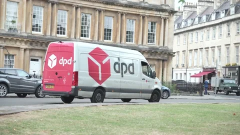 DPD delivery driver dropping off parcels and driving away Stock Footage 221172865