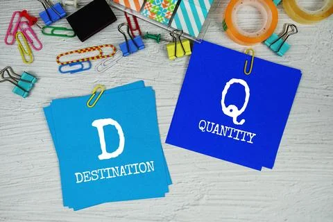 DQ - Destination Quantity text on stick note with stationery on concrete ba.. Stock Photos