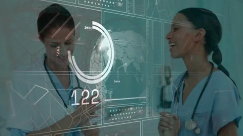 Dr  and  nurse checking data in ER HUD appearing over rotating globe and numeric Video stock 329785014