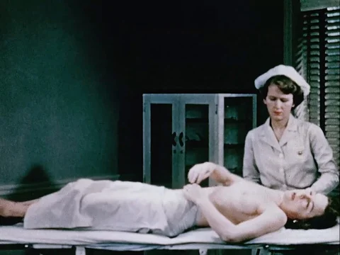 Dr. Johnson explains the patient on how to detect early cancer lumps - 1950 Stock Footage 111377926