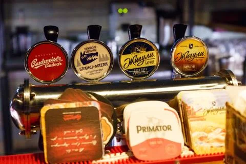 Draft beer bar taps with beer labels and name. Editorial Stock Photos