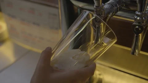 Draft Beer Being Poured from Tap into Glass at Bar Counter in Beijing, China Stock Footage 345756576