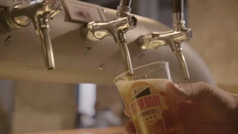 Draft Beer Being Poured from Tap into Glass at Bar in Beijing, China Interior Stock Footage 345758389