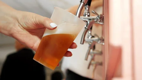 Draft Beer Pouring from Tap into Plastic Cup at Bar. Stock Footage 345781190