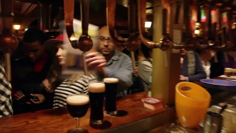 Draft Beer Taps and Patrons at Counter Interior Panning Shot 스톡 동영상 346694473