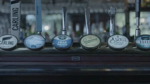 Draft Beer Taps Lined Up on Pub Bar Counter Stock-Footage 343096396