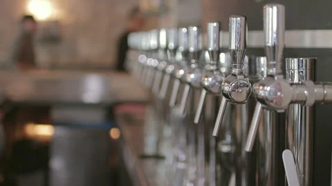 Draft Beer Taps in Row along Bar Counter Slow Motion Close Up Shot Vidéo 347374823