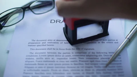 Draft law pending, officials hand stamping seal on business document, close up Stockbeeldmateriaal 100697004