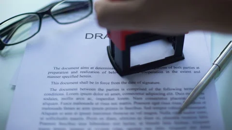 Draft law rejected, officials hand stamping seal on business document, close up Stockbeeldmateriaal 100696105