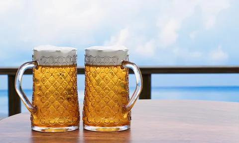 Draft or craft beer in a tall clear glass With beer foam on top And there are Illustrazione stock