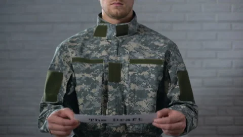The draft written on sign in soldier hands, compulsory military service, duty Stock Footage 107450948
