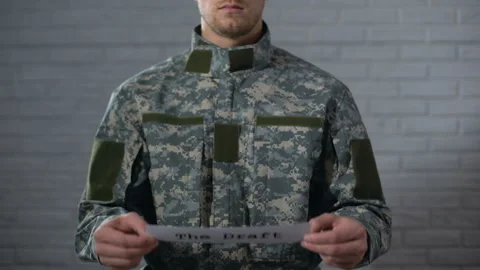 The draft written on sign in soldier hands, compulsory military service, duty 스톡 동영상 107452223