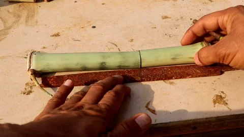 Drafting a knife on a file to make hidden bambo knife Stock Footage 150716338