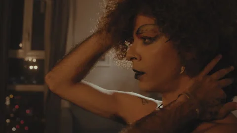 Drag queen adjusts wig and pouts in dressing room profile Stock Footage 275646774