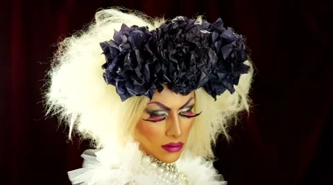 Drag queen with a glamorous look  making hush signal with finger across lips Stock Footage 56742311