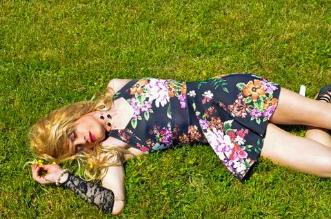 Drag queen lying on grass Stock Photos