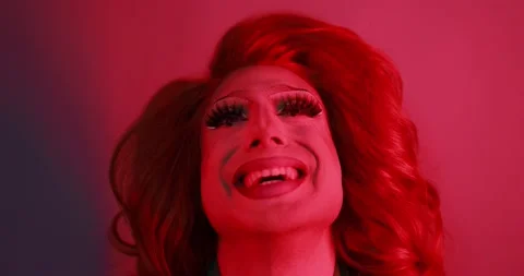Drag queen smiling on camera with red light inside studio - Lgbtq concept 動画素材 155437954