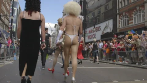 DRAG QUEENS MARCHING AND CELEBRATING PRIDE IN LONDON UK, HD Stock Footage 130656995